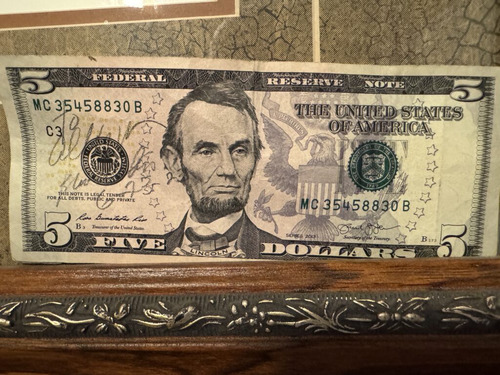 Five-dollar bill signed by Chris after our last round of golf together